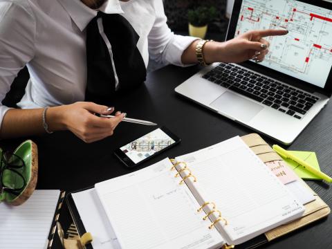 Woman working at a cluttered desk