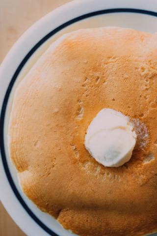 Fresh pancakes with butter on a breakfast plate