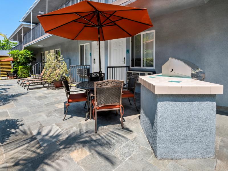 Gated courtyard with BBQ's, patio lounges, chairs, and tables